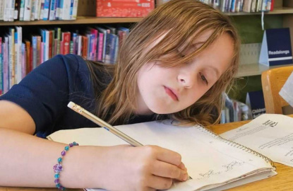 Kid writing in a notebook